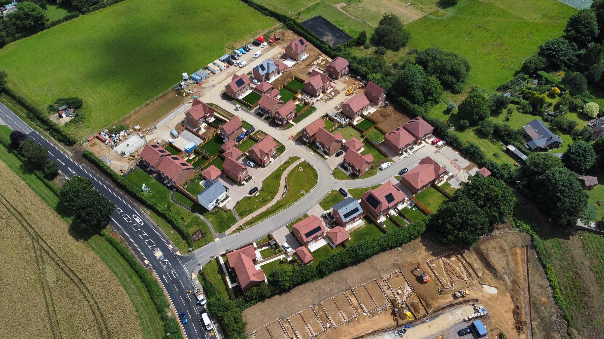 Aerial view of a residential development in its surrounding landscape